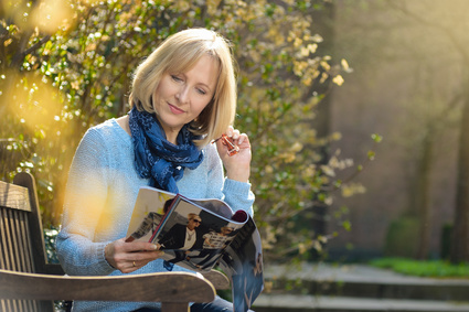 Photo of woman reading a magazine.